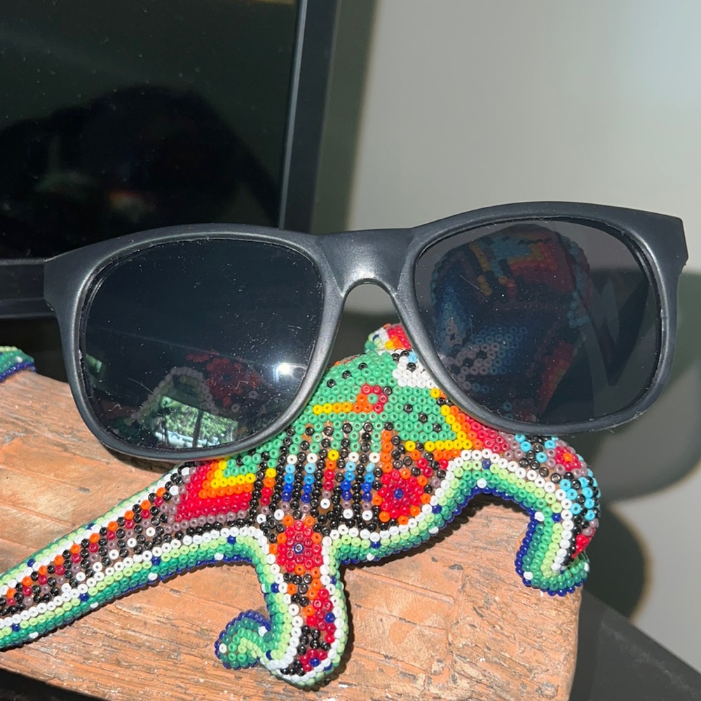 Black lightweight sunglasses. “Love Tito’s” Titos Handmade Vodka.